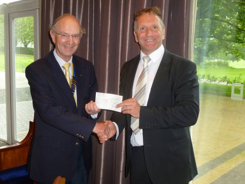 President Gordon giving a cheque for £3,000 to Sean Cahill.