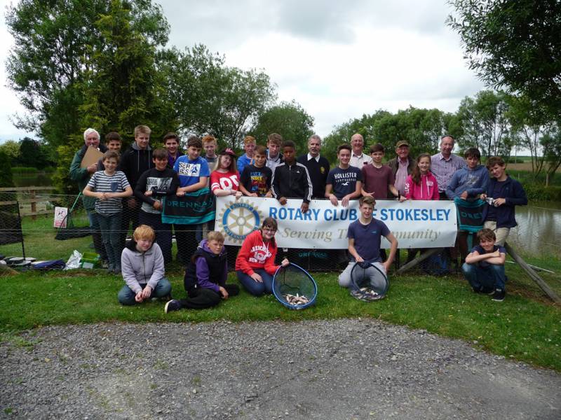 Celebrating another successful day's fishing last July, accompanied by their Rotarian instructors.