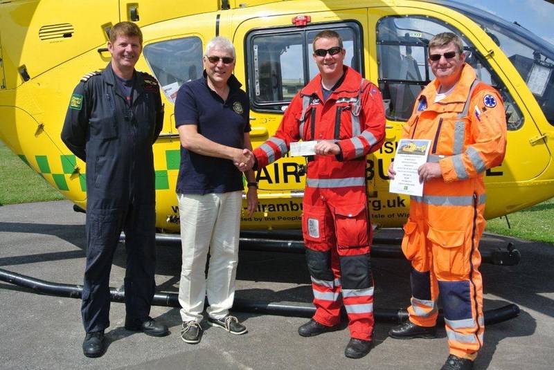 Basingstoke Loddon Rotary Club President, Ian Rosewell, presenting a £2,500 cheque to Crew Members of the Air Ambulance