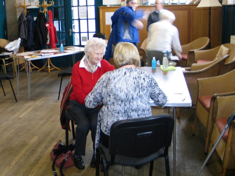 One of the visitors gets her blood pressure checked.