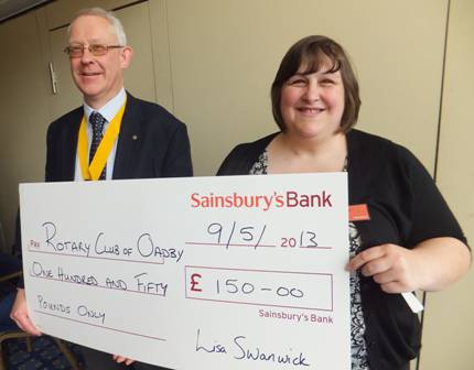 Karen Fincham, from Sainsbury's, presents a cheque to President Elect Philip Burrell