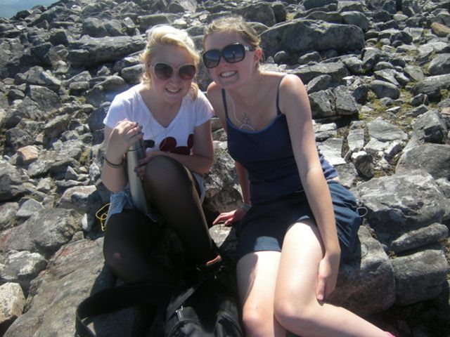 Emily and Hannah pose on rocks while on their RYLA course.