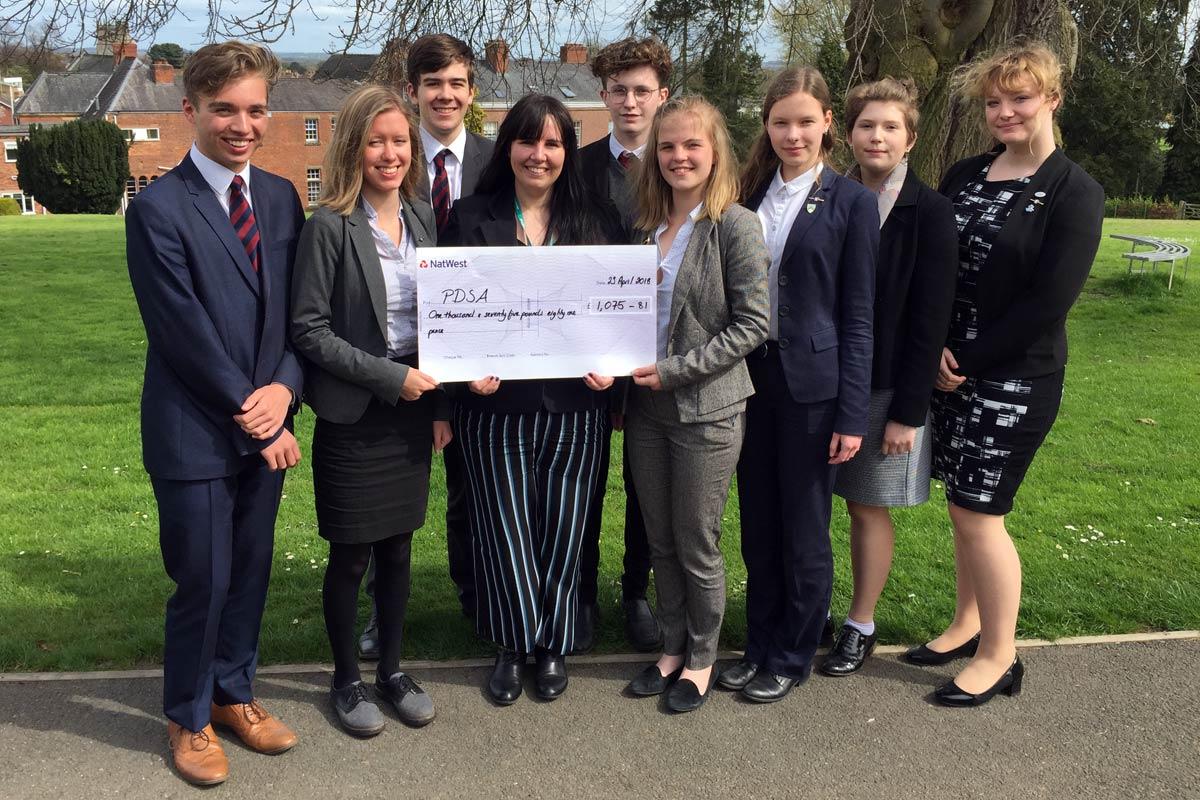 Members of Oswestry School Interact Group present the cheque for £1,075.81 to PDSA education officer Anna Baggott