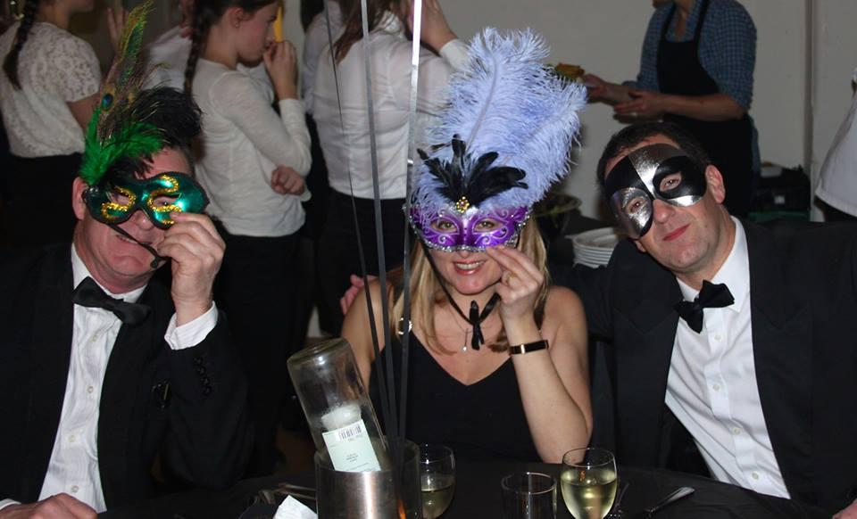 Party-goers revel in the glitzy evening at the Club's Charity Masquarade Ball.