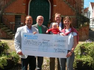 President Geoff Springett and David Houchell of Woodbridge Rotary Cub are seen here presenting a cheque for �1000 to Nicola and William Notcutt who are receiving it on behalf of the Deben Rowing Club.  

