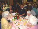 President Derek cheerfully hosts his table