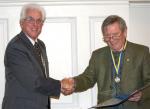  President Brian proudly presenting Past President John Stone with his Paul Harris Fellowship.