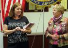 Helen is inducted by President Carol.