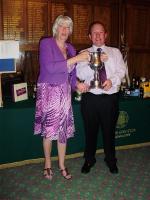 Rtn Ian Milnes receives the Rotary Ron Tudor trophy from Pauline Tudor