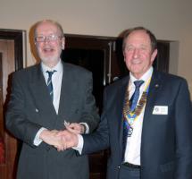 Roger presents a cheque to Hugh Barr for the Surgical Laser Charity.