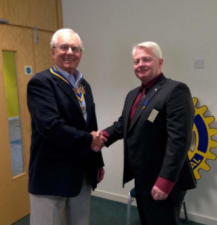 A relieved Immediate Past President, Paul, hands over to a still smiling President John