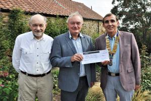 President David presenting a cheque to Anthony Glaister of charity ABCD Bethlehem with Rtnn Guy Wilson