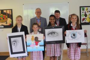 Pupils from Pipers Corner School, Great Kingshill display their winning artwork with President David Bevan and fellow Rotarian Andrew Warren.