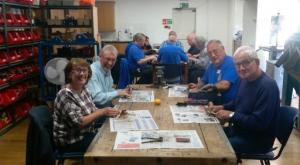 Barton le Clay Rotarians trying their hands at tool refurbishment.