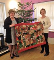 Quilt maker Mary Rawlins with Garden House Hospice's Helen Clark