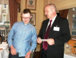 Sam receiving a cheque from Dave West