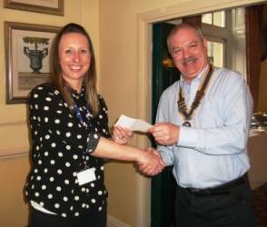Jenny Murgatroyd from Cancer Research UK receives a cheque from President Dave.