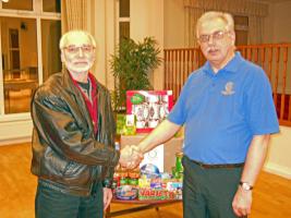Chairman of SMRC Projects, Rtn. Jim Austin presents food parcels to Chairman of Waves, Richard Plowman.