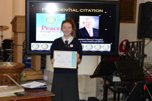 Interact president Rebecca Johnston with the Rotary International Presidential Citation.