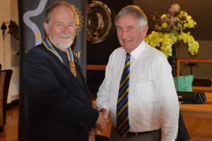 Incoming President Colin Strachan accepts the chain of office from Iain Smith.