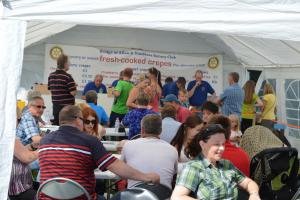 Crowds at the tent queuing for their orders and enjoying the sunshine.