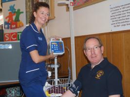 Emergency Nurse Practitioner Amanda Thurber of Oswestry Minor Injuries Unit takes President Stuart’s blood pressure