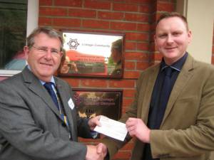 President Mike presenting a cheque.
