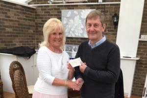 Katie Quickfall hands cheque to George Dougal