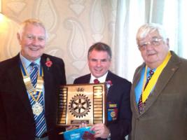 DG David Curtis presenting President Stuart with the District Conference Fancy Dress winners Plaque, together with President Elect Derek