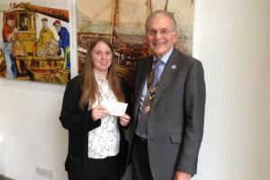 President Chris presents a cheque to Victoria