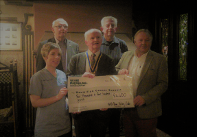 President Brian presents a cheque for Â£4400 to Dr Cherith Semple of Macmillan Cancer Care accompanied by the organising committee