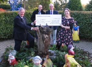Iain Smith, Stuart Brown and John Kilby present cheque to Sarah Secombes of CHAS in the garden of Rachel House.