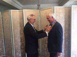 Presidential handover -- President Paul Fry receives the chain of office from his predecessor Rtn George Alford