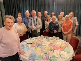 Betty Logan and Friends of Kilsyth knitted 150 sets of baby hats, jackets and bootees to be sent to Ukraine as part of Rotary's Ukraine Appeal.