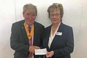 President Elect Mark Liquorish presenting speaker Carolyn McLaughlin with a cheque for Troop Aid