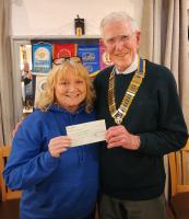 Lisa Ashton MBE receives the cheque from President Alan