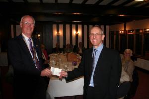 Malcolm Rolfe receiving a cheque on behalf of Hope and Homes for Children