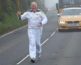 Keith Masdin carrying the Olympic Torch in Somerset, May 2012