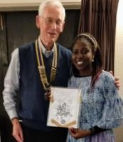 Naome receives a Club Banner from President Trevor to take back to her Rotaract Club in Uganda