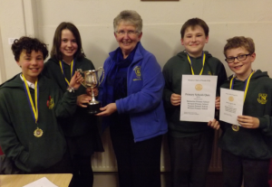 President Barbara Robertson of the Rotary Club of North Fife seen here presenting the winner's trophy to Newport Primary School's triumphant P7 quiz team.