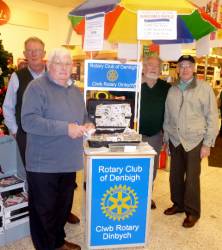 Selling tickets at Morrisons.  Mike, Alwyn, Brian and Gwilym stand by our new stand given to the club by Rotarian Mike (top left)