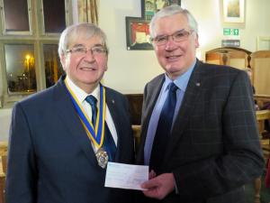 Borderland President Stan Smith presents President Mike with a cheque for Â£500 representing our Club's share of the collection at Oswestry's Christmas Parade