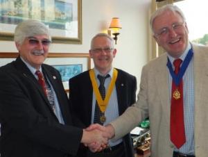 President Martin Wragg (right) hands over the chain of office to incoming president to David Knight (left) with Philip Burrell, who will be president in 2013-2014, looking on