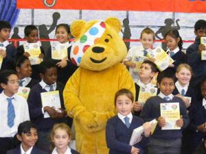 Pudsey Bear awards Dictionaries to children of St Mary’s R.C. Junior School.