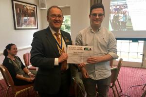 President Dave presents Harry with his certificate for RYLA.