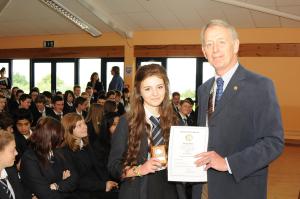 Immediate Past President Nigel Vince presenting Daniella Pink with the Young Writer Award, (Senior Section), during Year Ten Assembly at Ilfracombe Academy on 20th May 2014