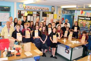 Students showing their bird boxes with Men's Shed members at the RWB Academy Success Lounge