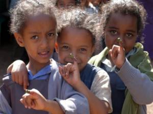 Children show off their painted little finger - purple dye is used to signify a completed immunisation.