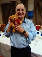 Lawrence holding Miles, the End Polio Now teddy bear.
