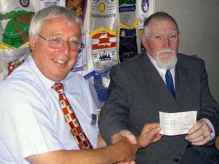 President Terry hands ?2,000 to Clive Hunt, Project Manager, The Green Hut
